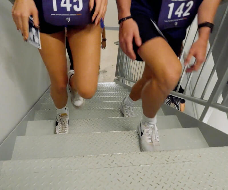Two people climbing up stairs 