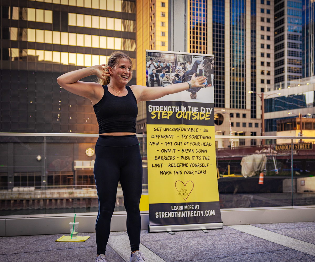 A fitness instructor leads an outdoor class